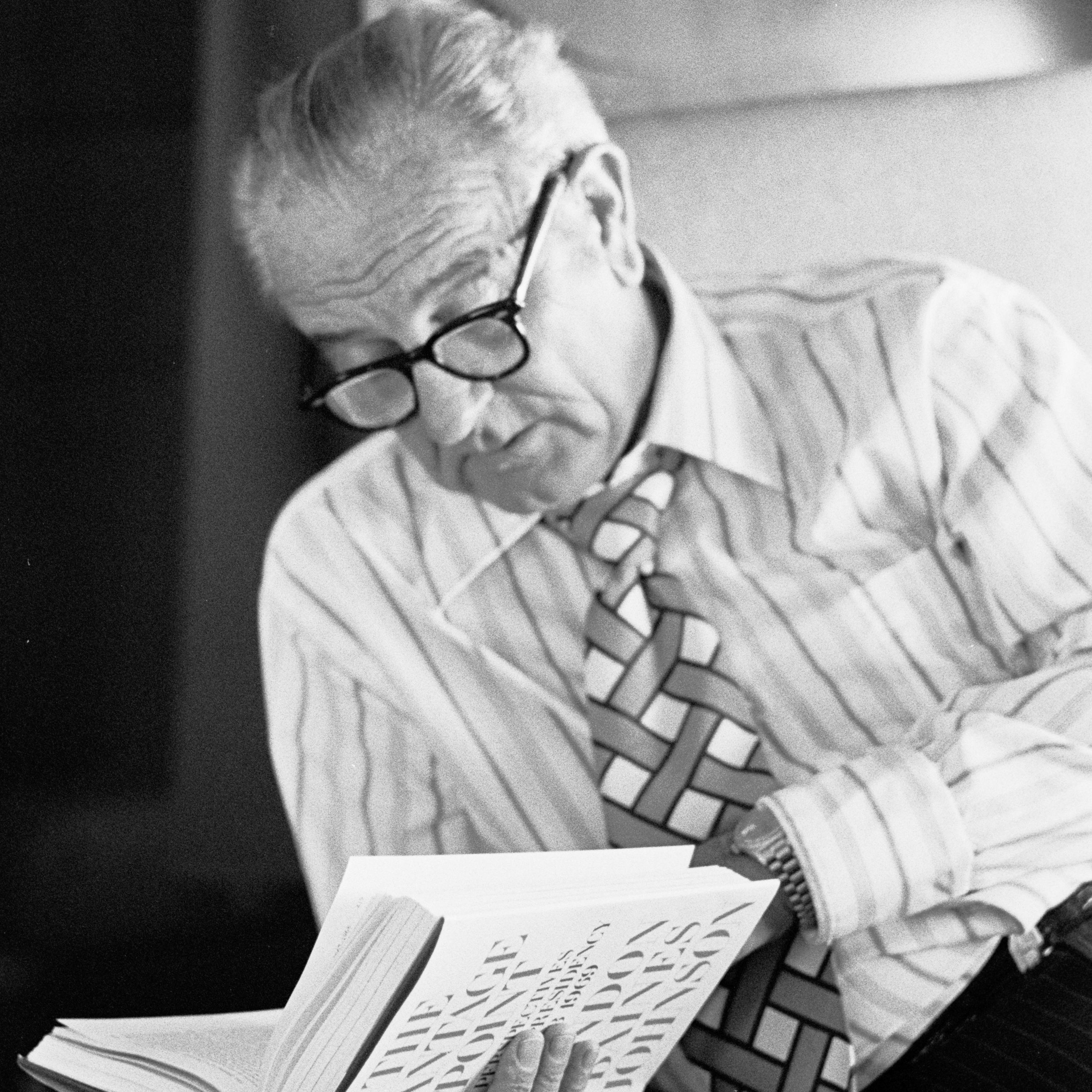 LBJ, with glasses, looks over his published memoir, "The Vantage Point."
